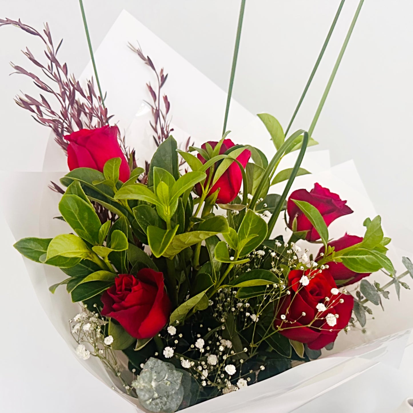 Valentine's Day Red Rose Bouquet with greenery and white wrap