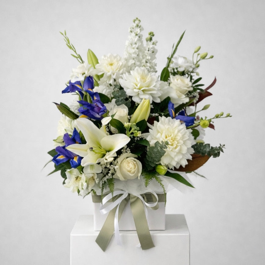 White lilies roses and blue iris flower arrangement, same-day sympathy flowers Castle Hill flower delivery