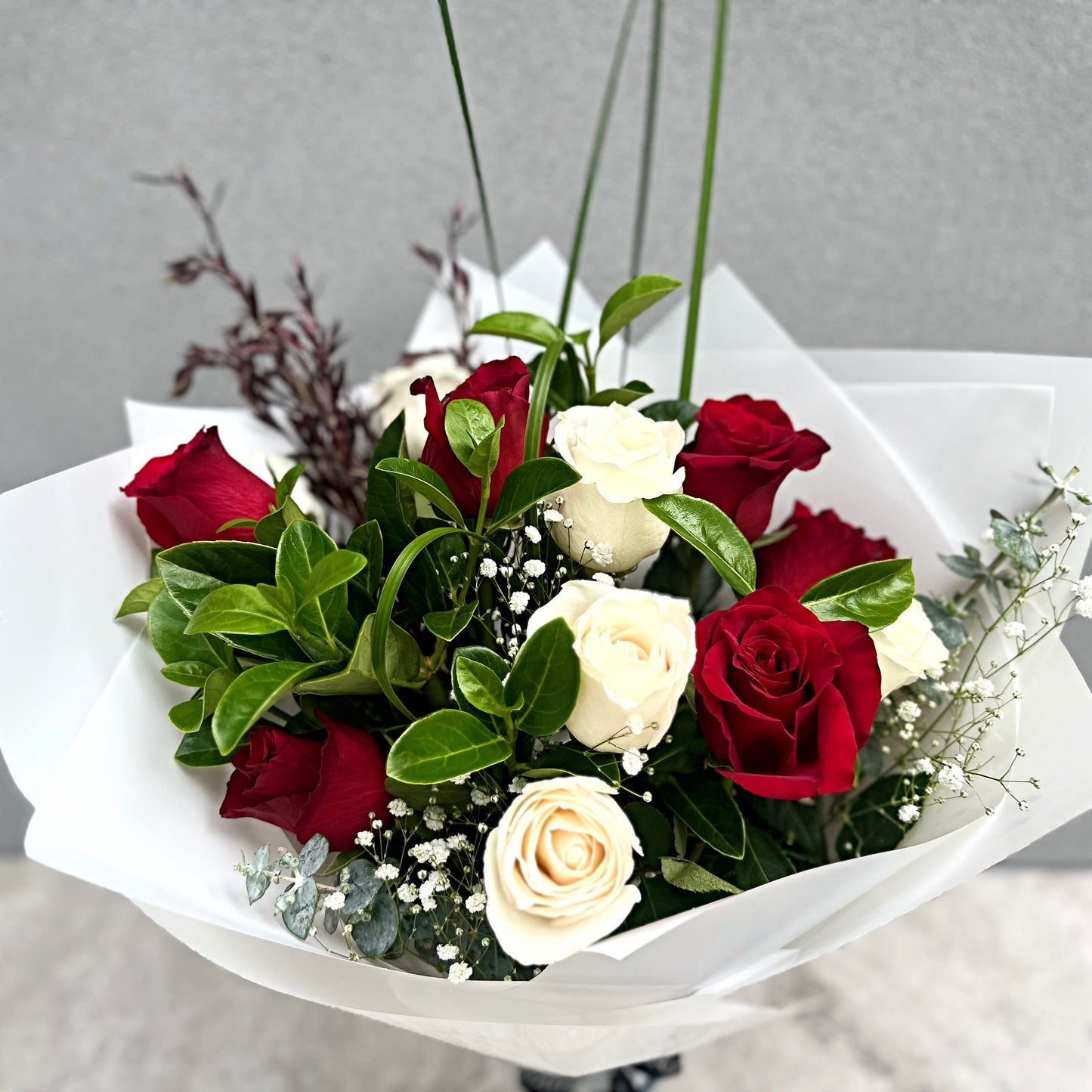 Classic Valentine's Day Red and White Rose Bouquet with greenery and Baby's Breath