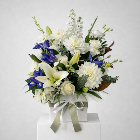 White lilies roses and blue iris flower arrangement, same-day sympathy flowers Castle Hill flower delivery