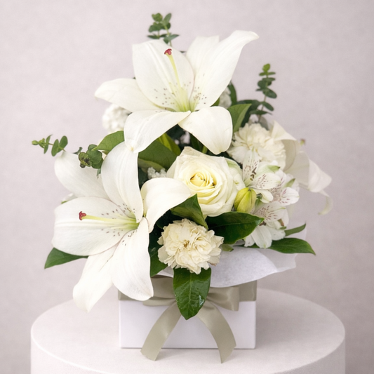 Elegant floral gift with white lilies paired with roses and seasonal blooms. Same day flower delivery Hills District, Parramatta and North Shore.