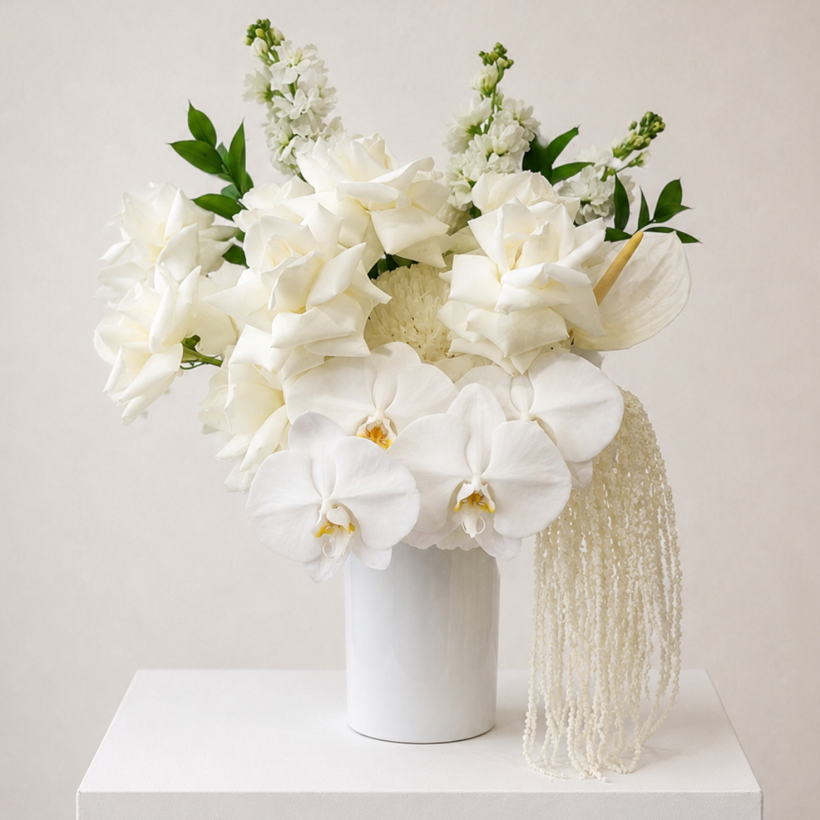 Luxury white orchid, reflexed rose and preserved hydrangea arrangement in a modern ceramic vase with cascading white Amaranthus by Bella Bloom Bar Sydney.