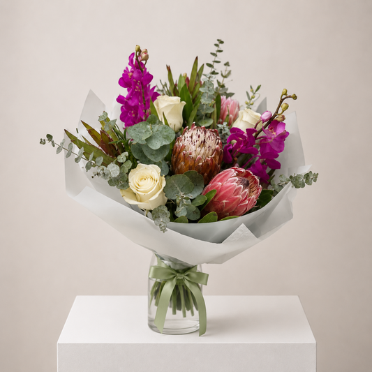 Wild Elegance Bouquet featuring king proteas, purple orchids, white roses and eucalyptus by Bella Bloom Bar Flowers delivery Sydney